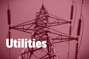 utilities in white and bold text hovering over an image of a electric pylon