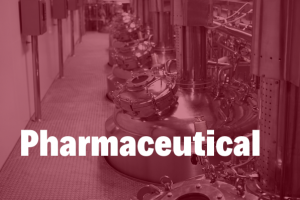 pharmaceutical in white bold text hovering over a in image of a pharmaceuticals processing facility